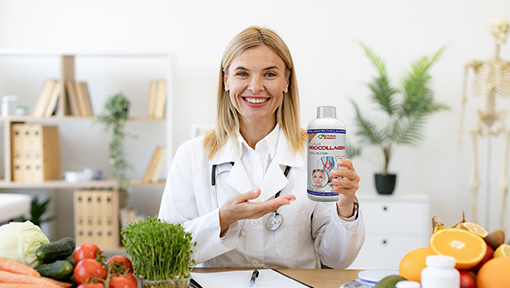 A smiling female doctor in a white coat holding a bottle of Procollagen, surrounded by fresh fruits and natural ingredients.