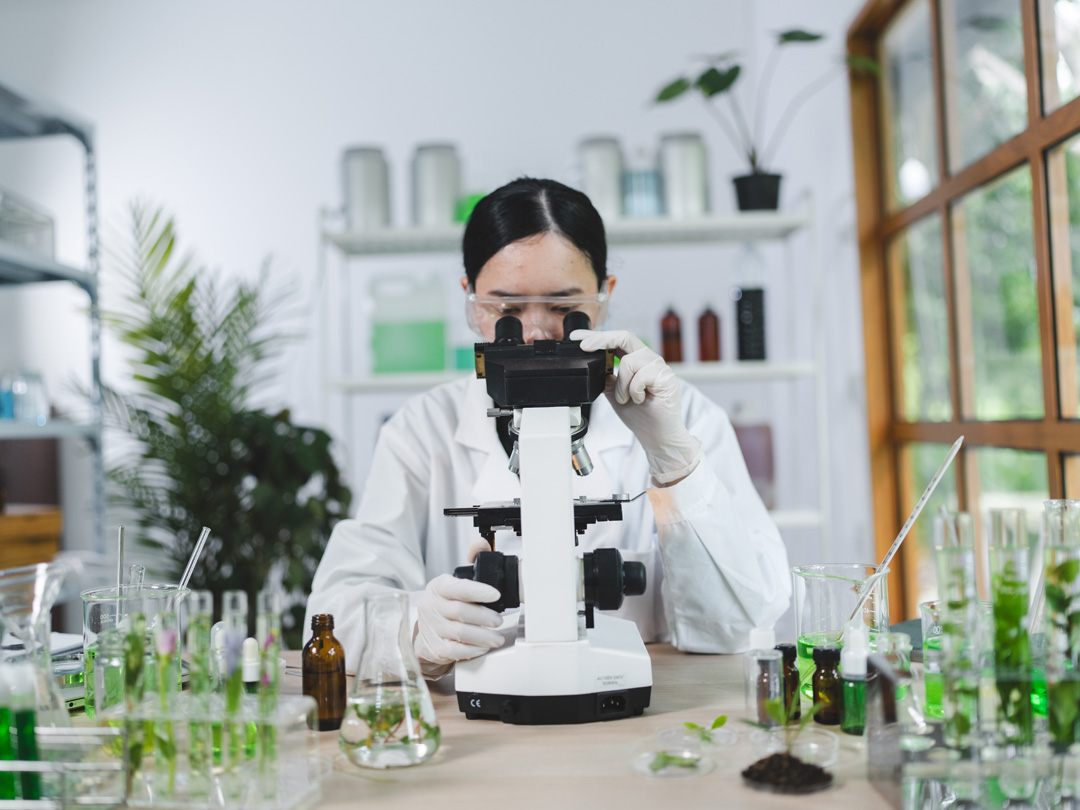A scientist in a modern lab analyzing plant extracts, visually reinforcing Vital Procollagen's philosophy of blending scientific precision with natural ingredients.