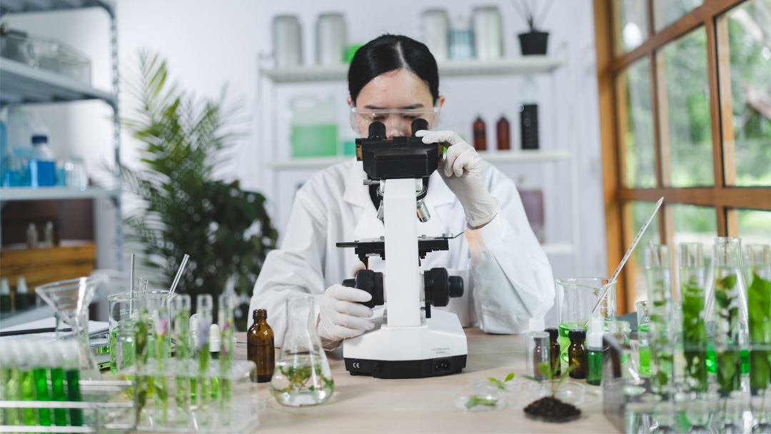 A scientist in a modern lab analyzing plant extracts, visually reinforcing Vital Procollagen's philosophy of blending scientific precision with natural ingredients.